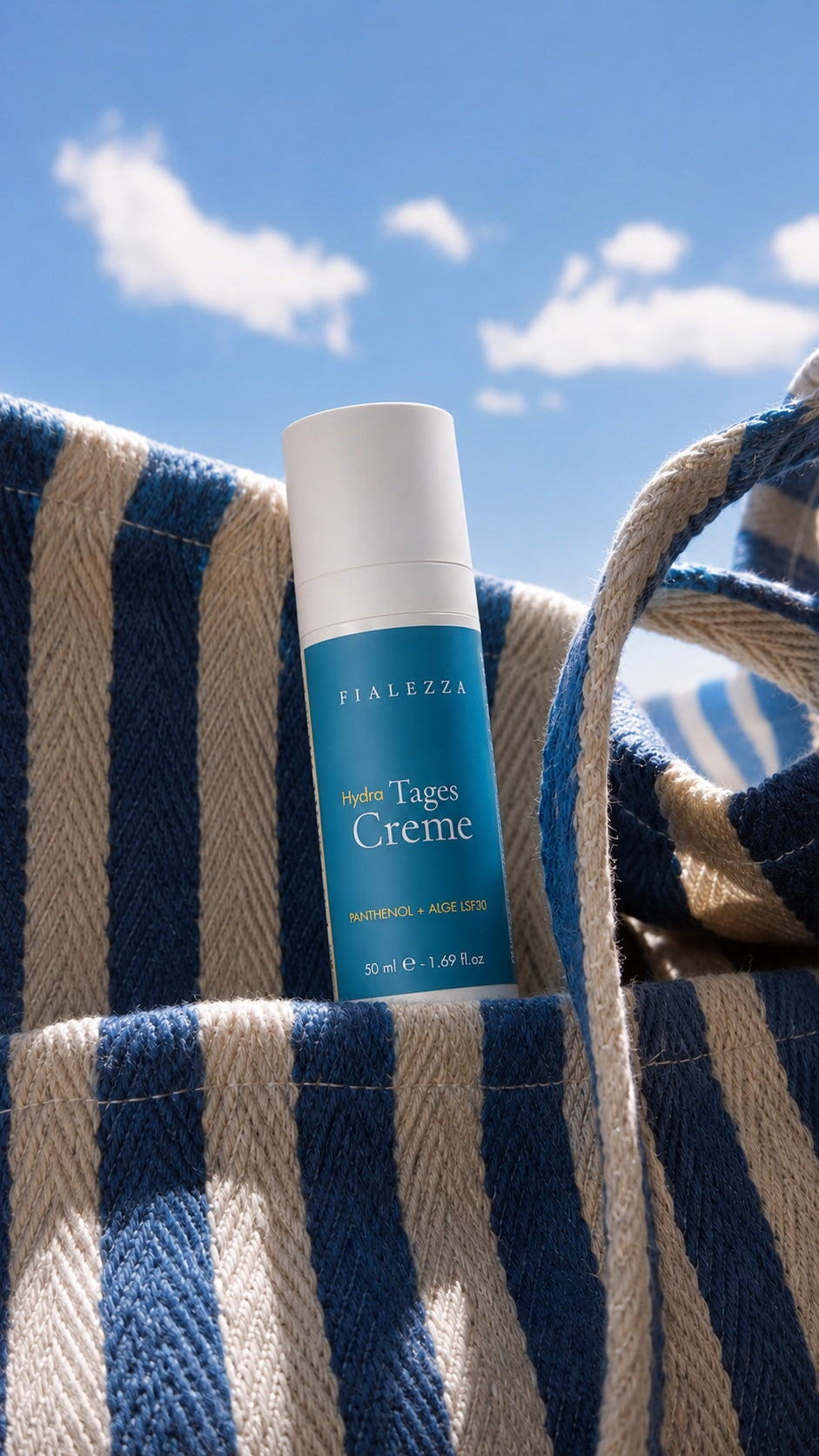 Fialezza Hydra Tages Creme mit LSF 30 in einer blau-weiß gestreiften Strandtasche